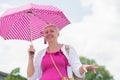 middle-aged woman with a short haircut with an umbrella protecting from sun Royalty Free Stock Photo