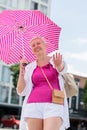 middle-aged woman with a short haircut with an umbrella protecting from sun Royalty Free Stock Photo