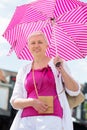 middle-aged woman with a short haircut with an umbrella protecting from sun Royalty Free Stock Photo