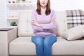 Middle aged woman sitting on the sofa at home background. Copy space and mothers day. Menopause and dieting Royalty Free Stock Photo