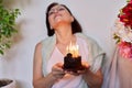 Middle-aged women with small birthday cake with candles Royalty Free Stock Photo