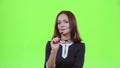 Middle aged woman with spectacles flirts in embarrassment. Green screen
