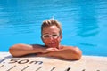 Middle-aged woman stands near the edge of the pool Royalty Free Stock Photo