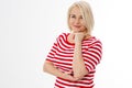 Middle-aged woman in a striped blouse posing on a white background Royalty Free Stock Photo
