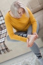 Middle-aged woman suffering from pain in leg at home, closeup. Physical injury concept. Royalty Free Stock Photo