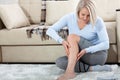 Middle-aged woman suffering from pain in leg at home, closeup. Physical injury concept. Royalty Free Stock Photo