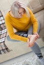 Middle-aged woman suffering from pain in leg at home, closeup. Physical injury concept. Royalty Free Stock Photo