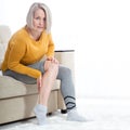 Middle-aged woman suffering from pain in leg at home, closeup. Physical injury concept. Royalty Free Stock Photo