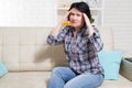 Middle-aged Woman suffering from stress or a headache grimacing in pain as she holds the back of her neck with her other hand to Royalty Free Stock Photo