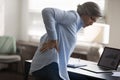 Middle-aged woman touch lower back, suffer from sudden backache