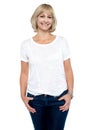 Middle aged woman in trendy clothing smiling at you Royalty Free Stock Photo