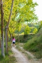 Middle-aged woman walking with her dog on a mountain path Royalty Free Stock Photo