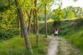 Middle-aged woman walking with her dog on a mountain path Royalty Free Stock Photo