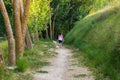 Middle-aged woman walking with her dog on a mountain path Royalty Free Stock Photo