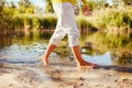 Middle-aged woman walking on river bank on autumn day. Senior lady having fun in the forest enjoying nature. Closeup Royalty Free Stock Photo