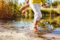 Middle-aged woman walking on river bank on autumn day. Senior lady having fun in the forest enjoying nature. Closeup Royalty Free Stock Photo