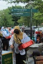 a middle-aged woman walking while selling mineral water to visitors