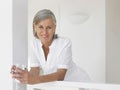 Middle Aged Woman With Water Glass On Verandah Royalty Free Stock Photo