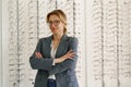 Middle-aged woman wearing glasses in optical store looks away Royalty Free Stock Photo