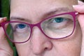 Middle-aged woman wearing glasses with pupils dilated of eyes, face woman in glasses, closeup Royalty Free Stock Photo