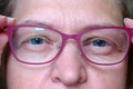 Middle-aged woman wearing glasses with pupils dilated of eyes, face woman in glasses, closeup Royalty Free Stock Photo