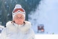 Middle-aged woman in a white jacket ski glasses Royalty Free Stock Photo