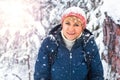 A woman walks in a winter Park among the pines