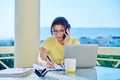 Middle-aged woman working in home office on terrace, talking on phone Royalty Free Stock Photo