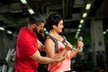 Middle aged woman working out with coach in gym Royalty Free Stock Photo