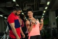 Middle aged woman working out with coach in gym Royalty Free Stock Photo