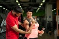 Middle aged woman working out with coach in gym Royalty Free Stock Photo