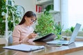 Middle-aged woman working remotely in home office, at workplace with computer Royalty Free Stock Photo