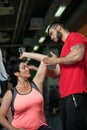 Middle aged woman working out with coach in gym Royalty Free Stock Photo