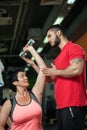 Middle aged woman working out with coach in gym Royalty Free Stock Photo