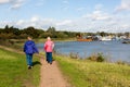 2 middle aged women enjoying a nice walk along the river Deben in the autumn sunshine on a clear sunny day