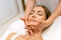 Middle-aged woman having a head massage in a beauty salon. Royalty Free Stock Photo