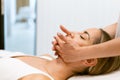 Middle-aged woman having a head massage in a beauty salon. Royalty Free Stock Photo