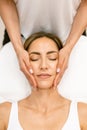 Middle-aged woman having a head massage in a beauty salon. Royalty Free Stock Photo