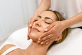 Middle-aged woman having a head massage in a beauty salon. Royalty Free Stock Photo