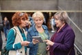 Middle-aged women with tablet PC near underpass.