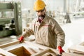 Middle aged worker working in the furniture factory Royalty Free Stock Photo