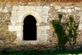 Middle ages ogival window in stone wall and ivy Royalty Free Stock Photo