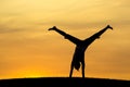 Middle of a cartwheel at sunset. Royalty Free Stock Photo