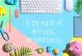 In the middle of difficulty lies opportunity message with office supplies Royalty Free Stock Photo