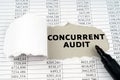 In the middle of the document with financial statements, there is a hole with the inscription - Concurrent audit Royalty Free Stock Photo