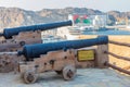 Ancient cannons overlooking the harbor at Muttrah Fort.