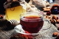 Middle East black tea in a cup with dried fruits and nuts. Vintage wooden background, selective focus Royalty Free Stock Photo