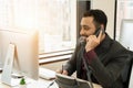 Middle east businessman talking on telephone call at business workplace Royalty Free Stock Photo