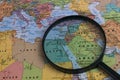 Map of Middle East through magnifying glass on a world map. Royalty Free Stock Photo