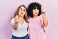 Middle east mother and daughter wearing casual clothes doing italian gesture with hand and fingers confident expression